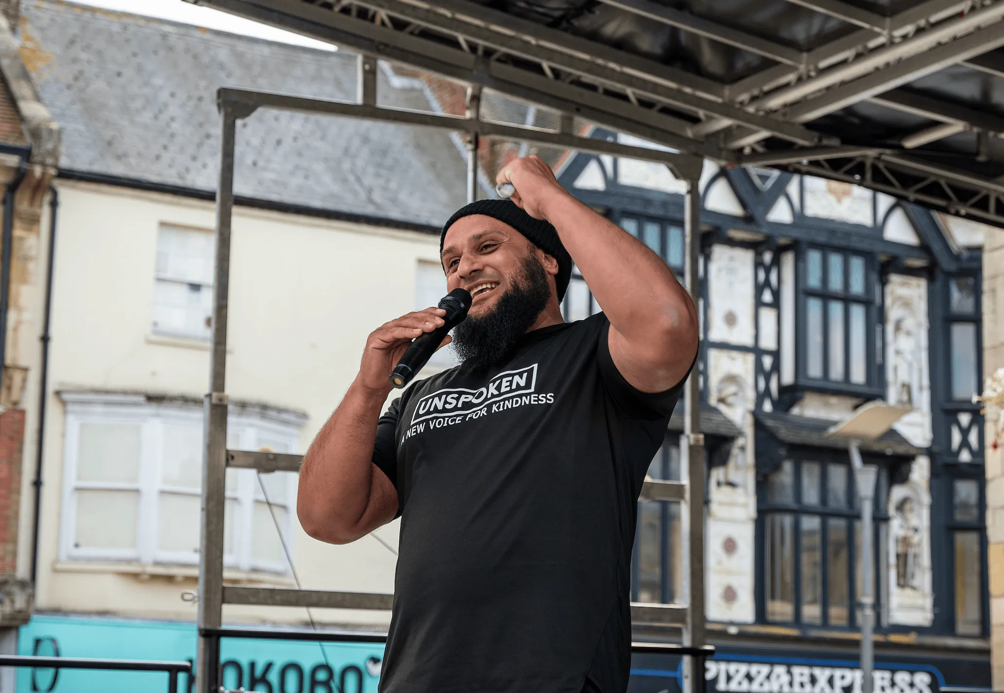 Atiq speaking in public at market square in Peterborough
